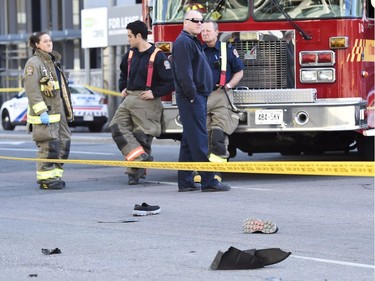 Shoes lay in the street as first responders secure the area in Toronto after a van mounted a sidewalk crashing into a number of pedestrians on Monday, April 23, 2018.