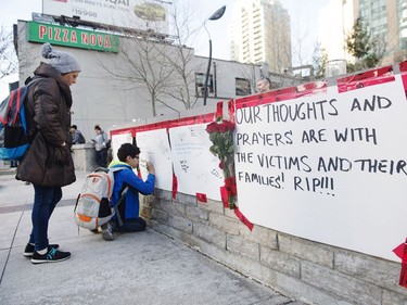 People sign a memorial in Toronto after a van mounted a sidewalk crashing into a number of pedestrians on Monday, April 23, 2018.