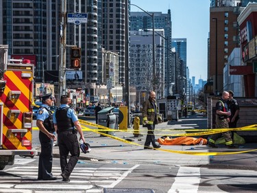 A body lies covered on the sidewalk in Toronto after a van mounted a sidewalk crashing into a number of pedestrians on Monday, April 23, 2018.