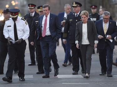 Toronto Police Chief Mark Saunders, front left to right, Toronto Mayor John Tory, Premier Wynne and Ralph Goodale, Federal Minister of Public Safety and Emergency Preparedness walk together towards a news conference after viewing the scene where nine people died and 16 others were injured when a van mounted a sidewalk and struck multiple pedestrians Toronto on Monday, April 23, 2018.