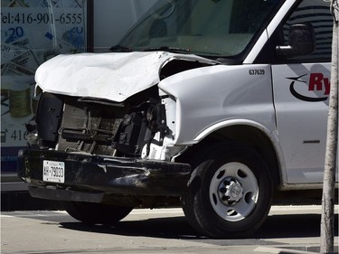 A van with a damaged front end is shown on a sidewalk after a van mounted a sidewalk crashing into a number of pedestrians in Toronto on Monday, April 23, 2018.