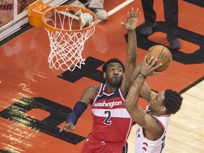 DeMar DeRozan of the Raptors takes a shot over the Washington Wizards' John Wall during first half action of Game 5 in their first round NBA playoff series  at the Air Canada Centre in Toronto.