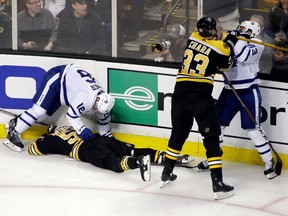Maple Leafs forward Nazem Kadri, far right, gets shoved by Bruins defenceman Zdeno Chara (33) after his late hit on Tommy Wingels, bottom left, during the third period of Game 1 on Thursday.
