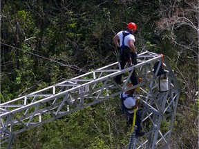 FILE - In this Oct. 15, 2017, file photo, Whitefish Energy Holdings workers restore power lines damaged by Hurricane Maria in Barceloneta, Puerto Rico. The Federal Emergency Management Agency said Oct. 27, it had no involvement in the decision to award a $300 million contract to help restore Puerto Rico's power grid to a tiny Montana company in Interior Secretary Ryan Zinke's hometown. FEMA said in a statement that any language in the controversial contract saying the agency approved of the deal with Whitefish Energy Holdings is inaccurate.