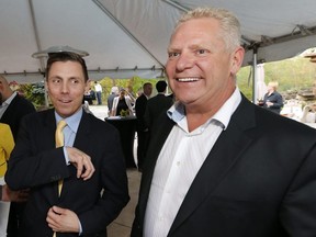 New Ontario PC leader Patrick Brown (left) is welcomed at a reception by Doug Ford at the Ford family house in Toronto, Ont. on Thursday May 14, 2015. Michael Peake/Toronto Sun/Postmedia Network