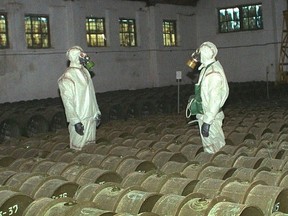 FILE - In this Saturday, May 20, 2000 file photo, two Russian soldiers make a routine check of metal containers with toxic agents at a chemical weapons storage site in the town of Gorny, 124 miles (200 kms) south of the Volga River city of Saratov, Russia. The facility in Shikhany led the efforts to develop Soviet chemical weapons, including Novichok-class nerve agents.