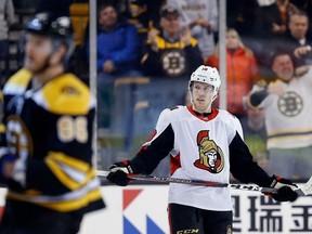 Ottawa Senators' Ryan Dzingel stands on the ice as fans celebrate the open-net goal by Boston Bruins' David Backes during the third period of an NHL hockey game in Boston, Saturday, April 7, 2018.