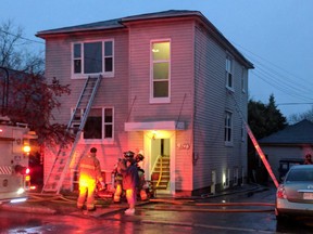 Firefighters at the scene of a blaze in an apartment building in Vanier Saturday, April 28.