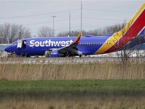 A Southwest Airlines plane sits on the runway at the Philadelphia International Airport after it made an emergency landing in Philadelphia, on Tuesday, April 17, 2018.