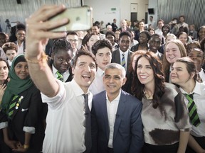 Canada's Prime Minister Justin Trudeau, left, takes a selfie with Mayor of London Sadiq Khan, center, and New Zealand's Prime Minister Jacinda Ardern at City Hall in London, Wednesday April 18, 2018, during the Commonwealth Heads of Government Meeting.