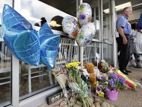 Flowers, balloons, and stuffed animals make up a makeshift memorial at the door to the Waffle House restaurant Wednesday, April 25, 2018, in Nashville, Tenn. The restaurant re-opened Wednesday after four people were killed by a gunman Sunday.