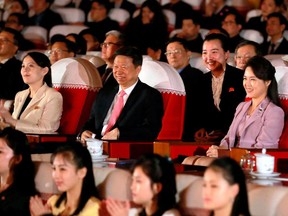 In this April 14, 2018, photo provided by the North Korean government, Ri Sol Ju, right, wife of North Korean leader Kim Jong Un, and Kim Yo Jong, left, sister of Kim Jong Un, watch a performance of a Chinese art troupe with Song Tao, center, head of the ruling Communist Party's International Department, in Pyongyang, North Korea. Six years into his reign, Kim Jong Un appears to be putting the spotlight on the women in his life. Over the past few months, Kim has increasingly shared the stage with his younger sister, who became an instant celebrity as his envoy to the Pyeongchang Winter Olympics, and his wife, a former singer in her late 20s. Independent journalists were not given access to cover the event depicted in this image distributed by the North Korean government. The content of this image is as provided and cannot be independently verified. (Korean Central News Agency/Korea News Service via AP)