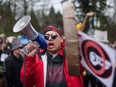 Cedar George-Parker addresses the crowd as protesters opposed to the Kinder Morgan Trans Mountain pipeline extension defy a court order and block an entrance to the company's property, in Burnaby, B.C., on April 7, 2018.