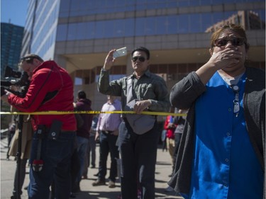 TORONTO, ONTARIO: People look on at the scene along Yonge Street near Finch Avenue after a man drove a rental truck down the sidewalk and hit and killed multiple pedestrians in Toronto, Ontario, April  23, 2018.