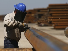 Jose Mata grinds a steel pipe at the Borusan Mannesmann plant in Baytown, Texas, Monday, April 23, 2018. President Donald Trump's escalating dispute with China over trade and technology is threatening jobs and profits in working-class communities where his "America First" agenda hit home. Without a waiver, Borusan Mannesmann Pipe may face tariffs of $25 million to $30 million annually if it imports steel tubing and casing from its parent company in Turkey, according to information the company provided to The Associated Press. (AP Photo/Loren Elliott)