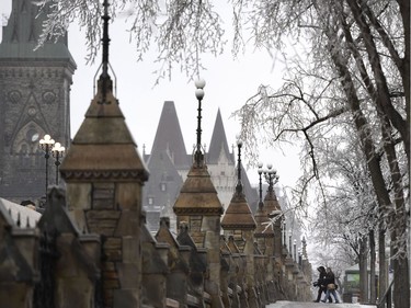 People arrive on Parliament Hill as a storm brings freezing rain in Ottawa on Monday, April 16, 2018.