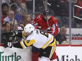 The Capitals' Tom Wilson (back) and Brian Dumoulin of the Penguins collide along the boards during Game 1 of their series. (Bruce Bennett/Getty Images)