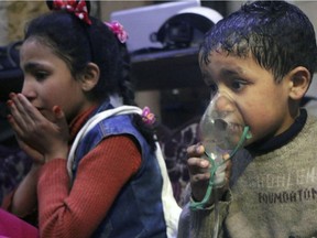This image released early Sunday, April 8, 2018 by the Syrian Civil Defense White Helmets, shows a child receiving oxygen through respirators following an alleged poison gas attack in the rebel-held town of Douma, near Damascus, Syria. Syrian rescuers and medics said the attack on Douma killed at least 40 people. The Syrian government denied the allegations. (Syrian Civil Defense White Helmets via AP)