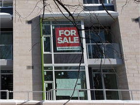 Condo with a for sale sign.