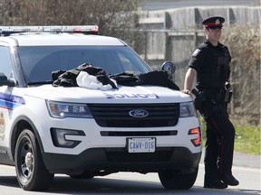 Police investigate near the scene of a homicide on Russell Road in Ottawa on Saturday, May 5, 2018.