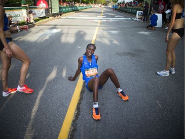 Gladys Kimaina the third place female sits down after crossing the finish line of the 10K race Saturday May 26, 2018 at Ottawa Race Weekend.