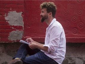 Artist Colin White sketching in a Chinatown alleyway.