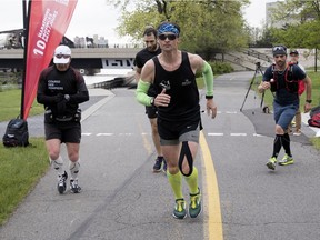 Patrick Charlebois, foreground, runs along the Lachine Canal in Montreal on Wednesday, May 23, 2018. Charlebois's Canadian Marathon Challenge is taking him from St. John's to Vancouver.