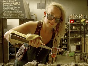 Lauretta Peters fashions a glass bird at the Flo Glassblowing studio on Gladstone Avenue.