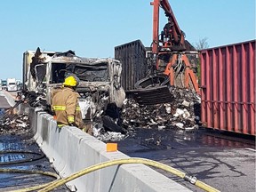 Crews at work on scene of fire in tractor trailer carrying load of frozen pizzas on Highway 401.