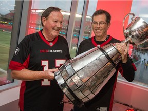 Jim Durrell, left, is introduced by Roger Greenberg as 2017 Grey Cup Festival chairman. Wayne Cuddington/Postmedia