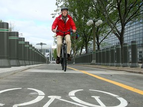 - Cyclists try out the new track, which runs in front of the American Embassy and beside the Chateau Laurier from the National Gallery (rear).  Ottawa mayor Jim Watson and other dignitaries officially opened the new Mackenzie Avenue cycling path Friday (May 19, 2017) at the York Street Pedestrian Crossing with a ribbon cutting. Julie Oliver/Postmedia