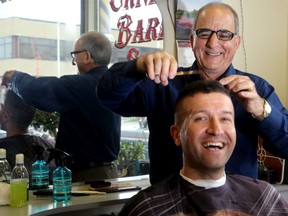 Ernesto Falbo, 75, is hanging up his scissors  after almost 50 years of keeping heads neat and tidy in the Glebe. He is seen here with Ashur Younan, who has been coming to Falbo for haircuts for 25 years, since he was 15. He was his last customer ever.