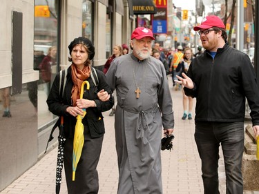 Pro-life protesters walk through the bubble zone area around the Morgentaler Clinic on Bank Street  (at rear under black canopy) on their way to the rally on Parliament Hill. Carrying pro-life placards, singing songs and chants, thousands of people paraded through downtown Ottawa Thursday (May 10, 2018) for the March for Life rally. They were met by a few hundred vocal pro-choice protesters at some intersections, but the two groups were kept separated by a strong police presence.