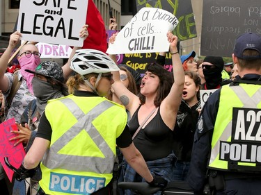 Police keep the pro-choice protesters at bay. Carrying pro-life placards, singing songs and chants, thousands of people paraded through downtown Ottawa Thursday (May 10, 2018) for the March for Life rally. They were met by a few hundred vocal pro-choice protesters at some intersections, but the two groups were kept separated by a strong police presence.