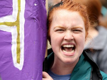 A young woman screams at the people in the pro-life rally as they passed by. Carrying pro-life placards, singing songs and chants, thousands of people paraded through downtown Ottawa Thursday (May 10, 2018) for the March for Life rally. They were met by a few hundred vocal pro-choice protesters at some intersections, but the two groups were kept separated by a strong police presence.