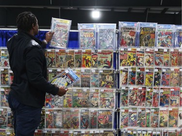 Comic book vendor gets his stall ready for the opening day of Comiccon, May 11, 2018.
