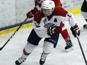 Stephen Uhler/Pembroke Daily Observer/Postmedia Network Pembroke Lumber King Connor Warnholtz (22) clears the puck from behind the Ottawa Junior Senators' net, while being followed by Ottawa's Owen Guy (12) and Devon Daniels (7), and Pembroke's Malcolm Arseneau (23) during Sunday night's game at the Pembroke Memorial Centre.