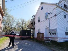 A Smiths Falls Police officer secures the scene of a fatal fire at 80-82 Victoria Avenue in Smiths Falls, Ontario. May 7,2018. Errol McGihon/Postmedia