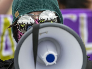 Ottawa Police are reflected in the sunglasses of a Pro-Choice supporter as a group blocked the annual March for Life in Ottawa Thursday, May 10, 2018.