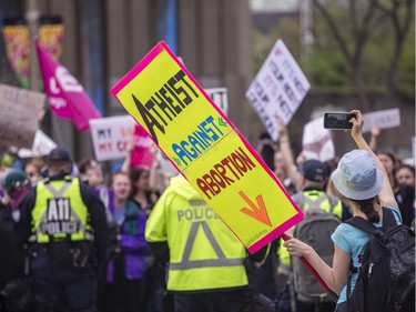 A pro-life supporter takes pictures after pro-choice supporters blocked the annual March for Life in Ottawa Thursday, May 10, 2018.