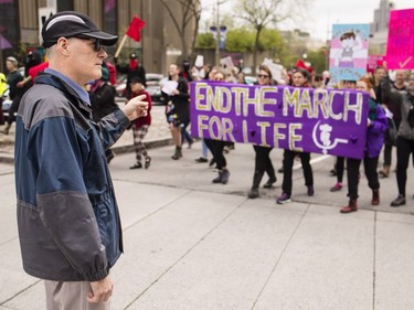 A man, presumably a pro-life supporter, points to an oncoming Pro-Choice march before they confronted and blocked the annual March for Life in Ottawa Thursday, May 10, 2018.