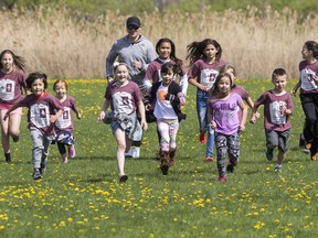 Chief Troy Thompson runs with kids from the Ahkwesahsne Mohawk School. Thomson is running the full marathon on Race Weekend to raise funds to battle obesity in his community. 30 kids from Ahkwesahsne are running to support him. Together they hope to defeat the stigma in his community around health and fitness. Errol McGihon/Postmedia