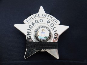 CHICAGO, IL - FEBRUARY 16:  Chicago police stand outside of the Nativity of Our Lord church in the Bridgeport neighborhood to honor Commander Paul Bauer as his remains are carried into the church on February 16, 2018 in Chicago, Illinois. Bauer was shot and killed on February 13, while trying to help stop a man being pursued by tactical officers in the city's downtown. Bauer's funeral is scheduled for tomorrow.  (Photo by Scott Olson/Getty Images)