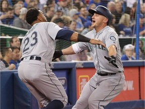 Kyle Seager of the Seattle Mariners is congratulated by Nelson Cruz after hitting a solo home run in the fifth inning during MLB game action against the Toronto Blue Jays at Rogers Centre on May 10, 2018.