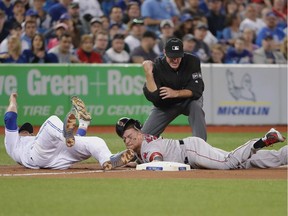 Christian Vazquez #7 of the Boston Red Sox is tagged out at third base trying to steal in the seventh inning during MLB game action as Russell Martin #55 of the Toronto Blue Jays tags him out at Rogers Centre on May 12, 2018 in Toronto.