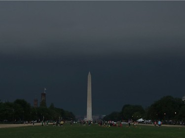 WASHINGTON, DC - MAY 14: People play sports on the National Mall as the front of a severe thunderstorm approaches,  on May 14, 2018 in Washington, DC. The area was hit with heavy rain and high winds from the early evening storm.