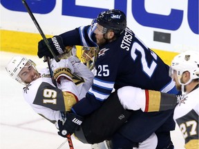 Reilly Smith #19 of the Vegas Golden Knights is checked by Paul Stastny #25 of the Winnipeg Jets during the second period in Game Two of the Western Conference Finals during the 2018 NHL Stanley Cup Playoffs at Bell MTS Place on May 14, 2018 in Winnipeg.