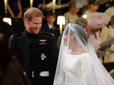 Prince Harry looks at his bride, Meghan Markle, as she arrived accompanied by Prince Charles, Prince of Wales during their wedding in St George's Chapel at Windsor Castle on May 19, 2018 in Windsor, England.