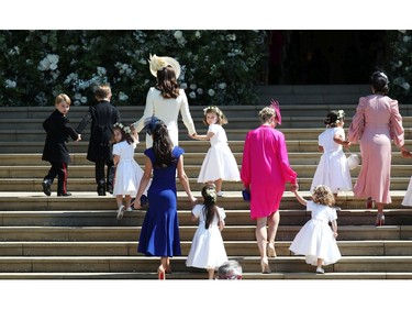 Prince George of Cambridge,  Jasper Dyer, Princess Charlotte of Cambridge, Catherine, Duchess of Cambridge, Jessica Mulroney, Ivy Mulroney, Florence van Cutsem, Zoe Warren, Zalie Warren, Benita Litt, Remy Litt and Rylan Litt arrive at St George's Chapel at Windsor Castle for the wedding of Prince Harry and Meghan Markle in St George's Chapel at Windsor Castle on May 19, 2018 in Windsor, England.