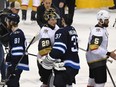 Vegas goaltender Marc-Andre Fleury talks with Winnipeg counterpart Connor Hellebuyck in the handshake line after Game 5.
